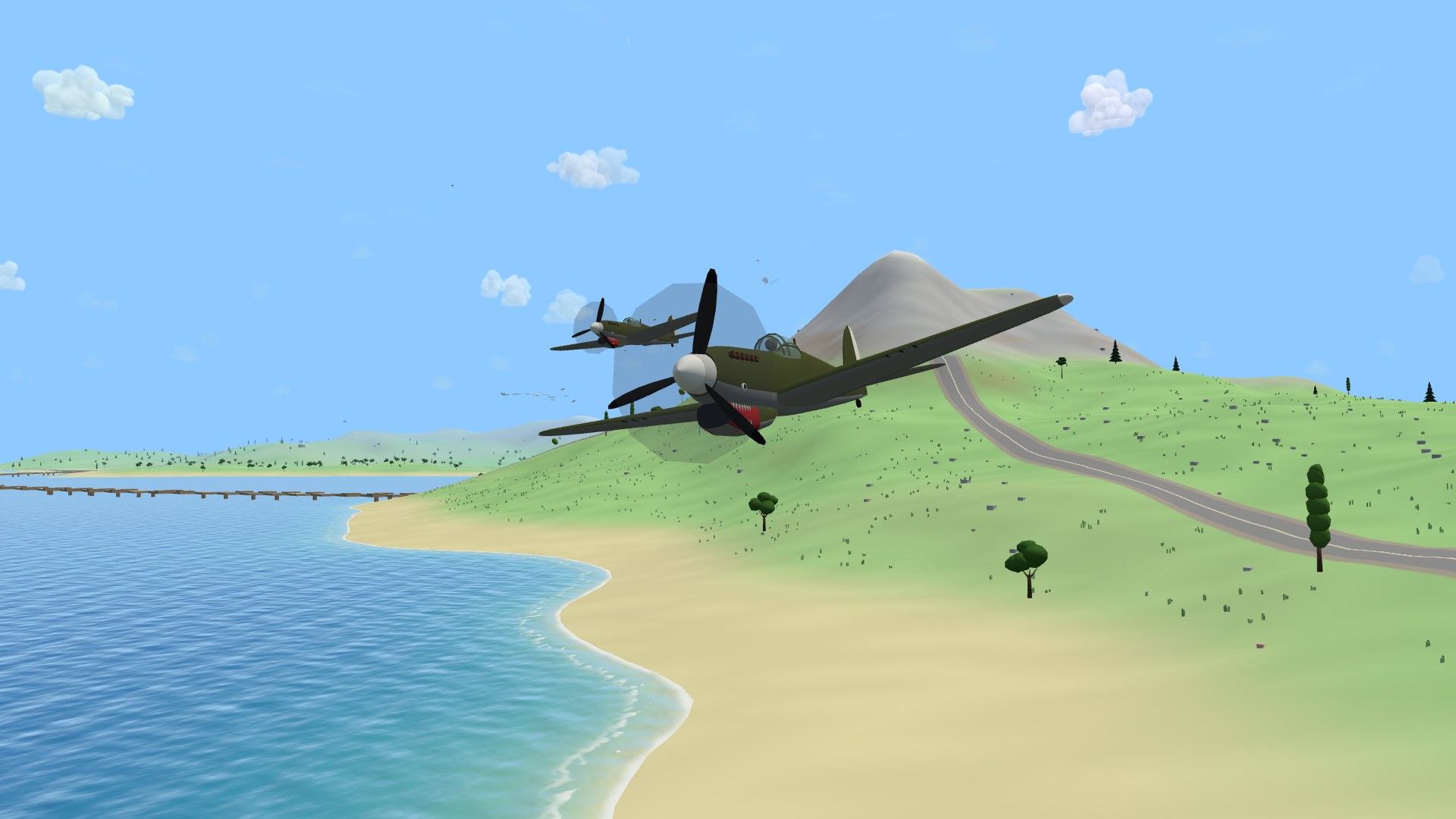 A P-40N Warhawk flying almost straight at the camera low over a beach, its painted shark mouth bared under the propeller, a second Warhawk behind it